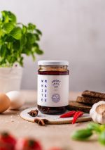 Chili oil in context on a cutting board with spices around